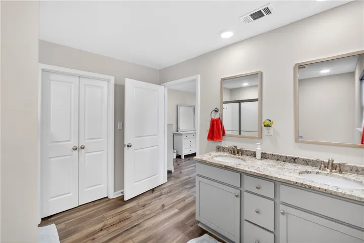 Indulge in a primary bathroom featuring a spacious double vanity with granite countertops.