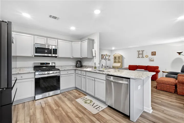Culinary creations come to life in this kitchen, boasting bright countertops and modern appliances.