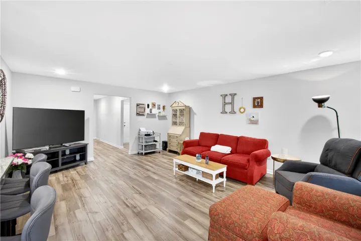Natural light illuminates this spacious living area with durable wood-style flooring throughout.