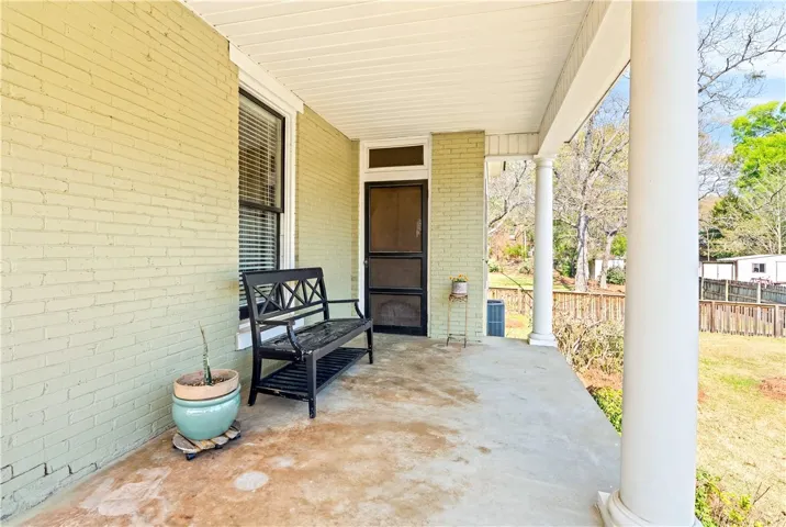 Side front porch leading to primary bedroom