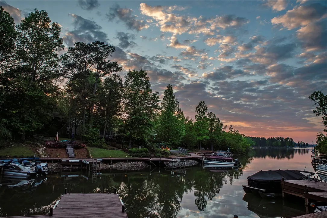This serene waterfront property boasts direct lake access and private boat docks under a captivating sky.
