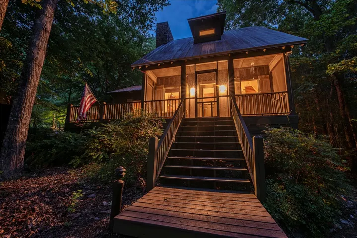 This charming home features a welcoming porch, perfect for enjoying the serene outdoor surroundings.