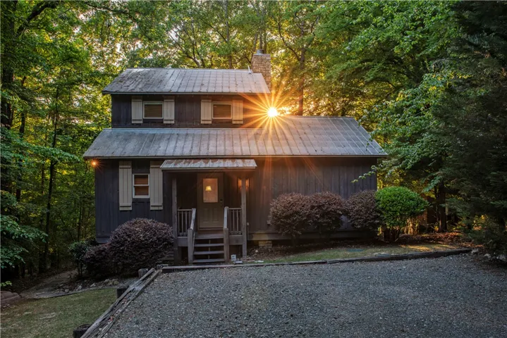 This charming home is nestled among a lush forest, offering a serene and private escape.