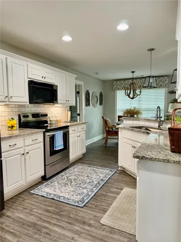 Culinary delights await in this bright kitchen with ample counter space and modern appliances.