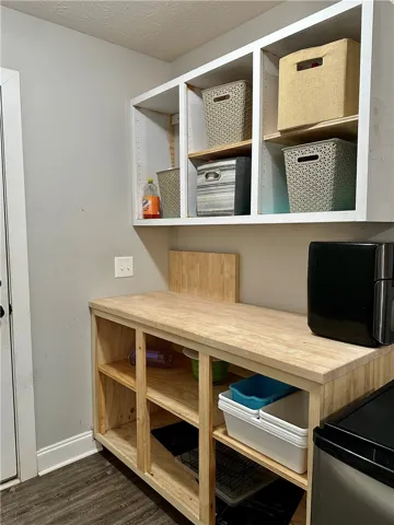 Functional utility space with open shelving offers practical storage solutions.