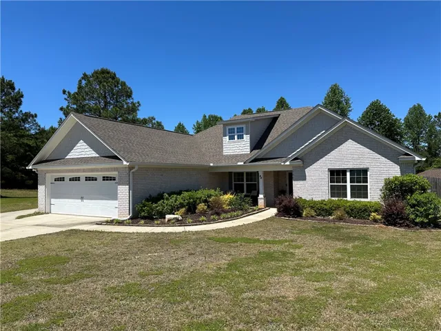 This charming residence features an inviting exterior with mature landscaping and a spacious driveway.