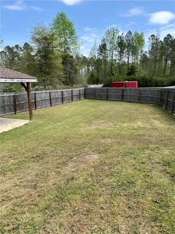 This spacious yard offers ample outdoor living space, perfect for relaxation and recreation.