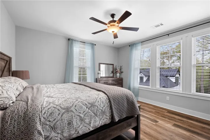 Bedroom 2 offers abundant natural light with a wall of windows.