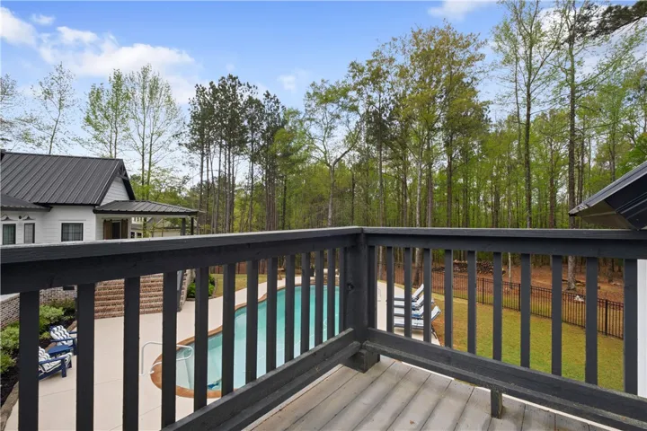 Private apartment deck overlooking the pool and yard.