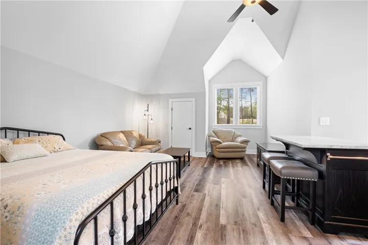 Above the three-car garage, a private apartment offers a bedroom, full bath, kitchen, and generous storage.