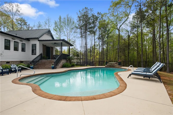 The primary bedroom opens to a private porch with direct access to the pool deck.