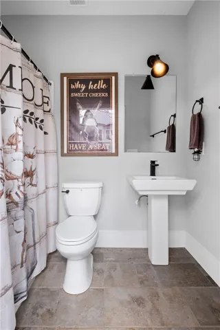 A full bath is conveniently located just beyond the pool on the ground level.