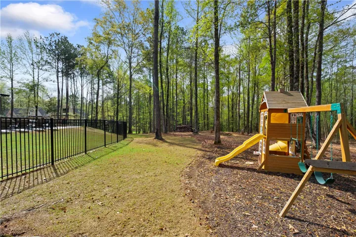 A playset just beyond the pool extends the fun for an all-day outdoor experience.