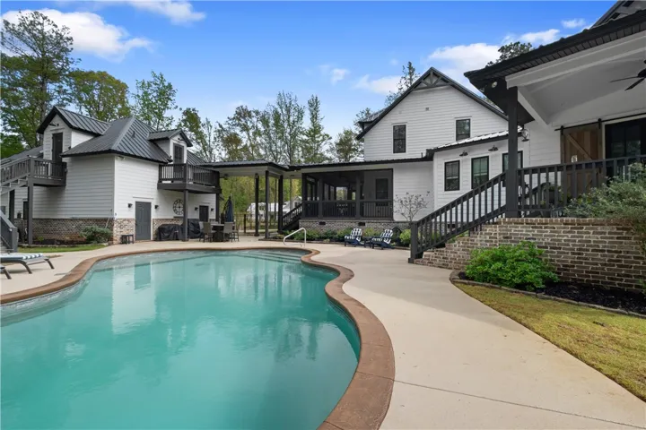 An inviting pool with a spacious deck, multiple porches (screened and open), a 3-car garage connected by a breezeway, a private apartment above, and expansive acreage—thoughtfully combined into one exceptional estate.