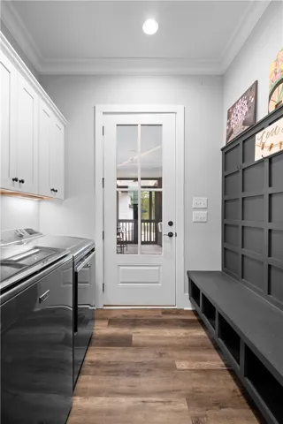 The laundry room doubles as a mudroom, featuring a built-in drop zone for everyday convenience.