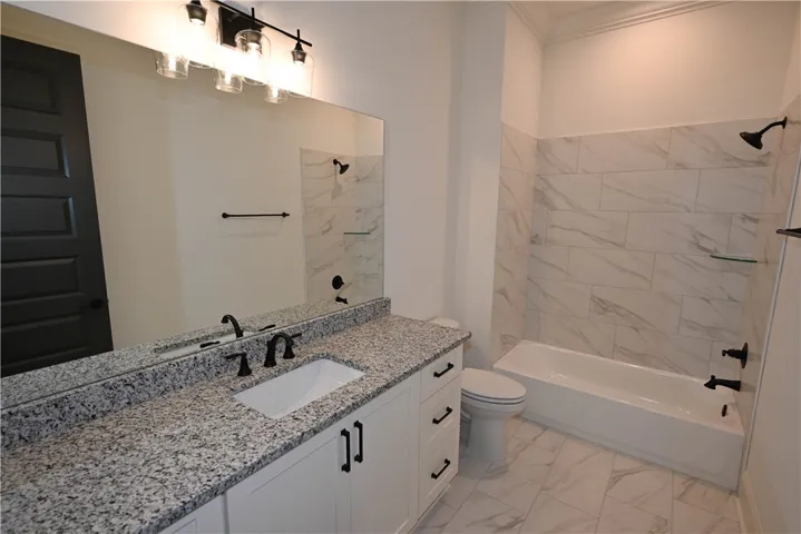 Tiled bathroom shared between bedroom 2 & 3.