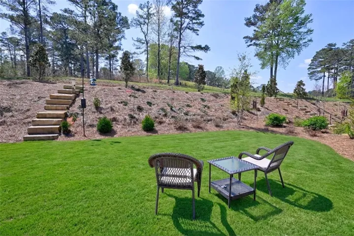 Backyard with private steps leading to nature trail and golf course.