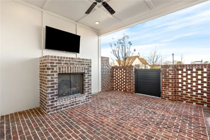 PRIVATE COVERED PATIO WITH GAS FIREPLACE INCLUDING MOUNTED TV
