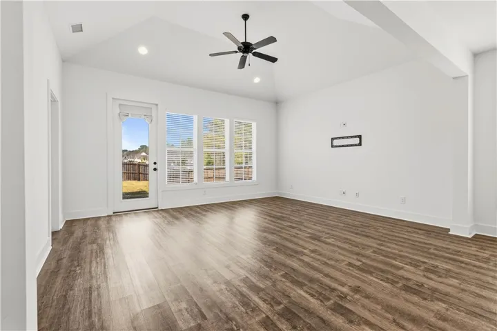 Roomy living room w/sunshine & vaulted ceilings.  Offers versatility in layout too!