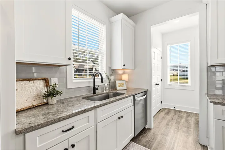Full bowl sink w/delta faucet, this space leads to dbl-door pantry.  So much sunshine for whipping up wonderful meals!