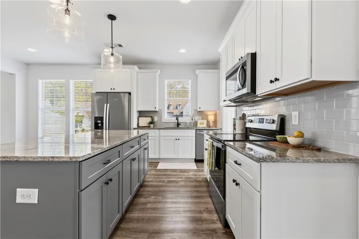 Two-toned, generous island.  Upgraded pendant lights.  Black hardware.  Whirlpool appliances.  Great kitchen space!