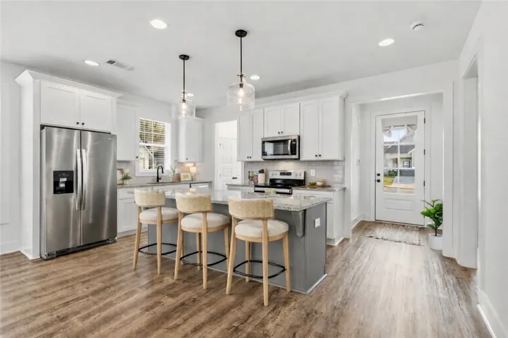 Well-equipped w/lots of cabinets & counter space and bar seating.  (Bar stools virtually staged)