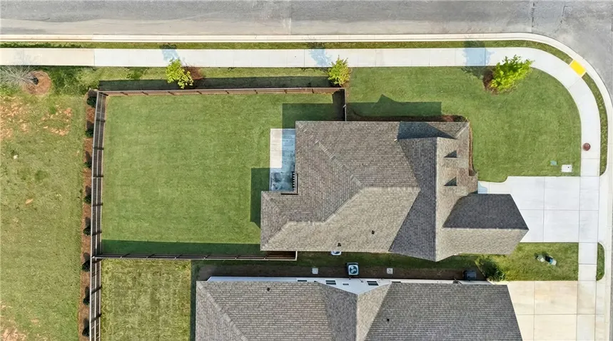 Aerial view. Fully fenced, flat back yard w/wooded views!  (Grass has been virtually enhanced to resemble spring!)
