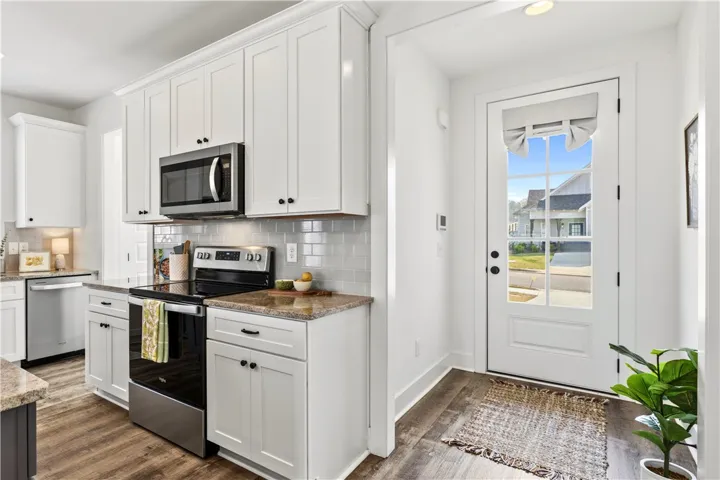 Quaint & sunny entryway provides privacy while also quick kitchen access for unloading​​‌​​​​‌​​‌‌​‌‌​​​‌‌​‌​‌​‌​​​‌​​ groceries.