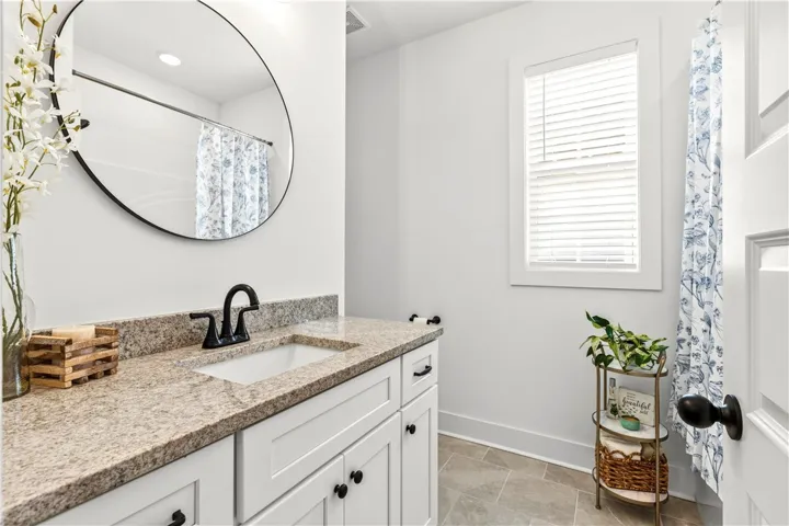 Guest bath - great layout!  Roomy plus large vanity, tucked toilet & tub/shower.  You could say this room has its own curb appeal!