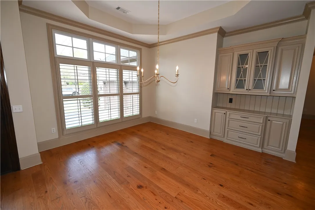 Formal dining room adorned with a chandelier and beautiful built-ins!