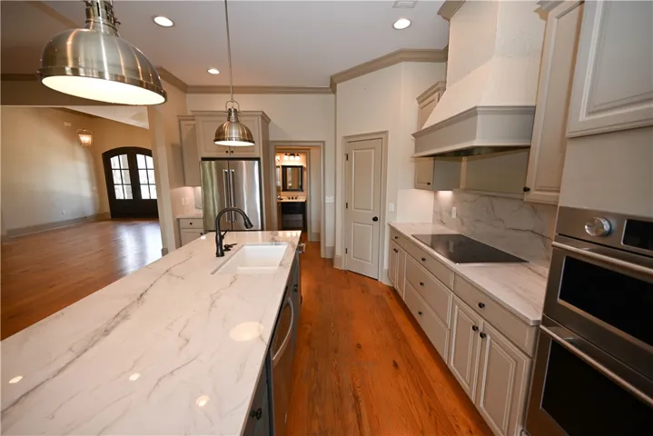 Electric cooktop, custom cabinetry with under cabinet lighting!