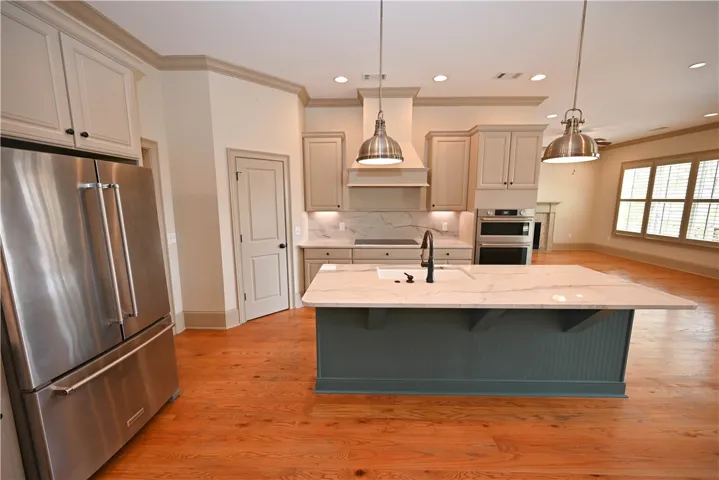 Huge kitchen with lovely accents and stainless steel appliances.