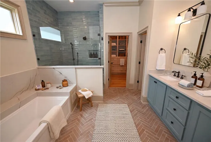 Luxurious primary bathroom with walk-in closet featuring built-ins! (DIGITALLY STAGED)
