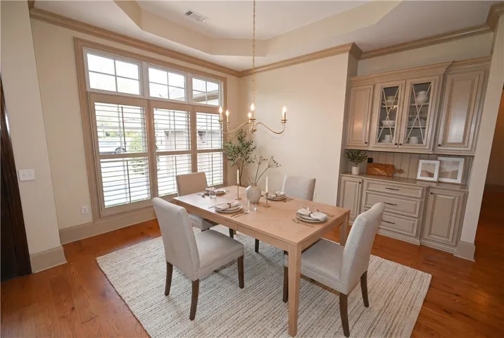 Light-filled formal dining room (DIGITALLY STAGED)