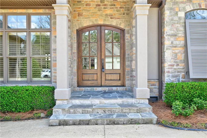 Columned arches leading to the elegant double doors!