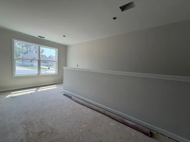 This bright space offers potential for customization and comfort with ample natural light.