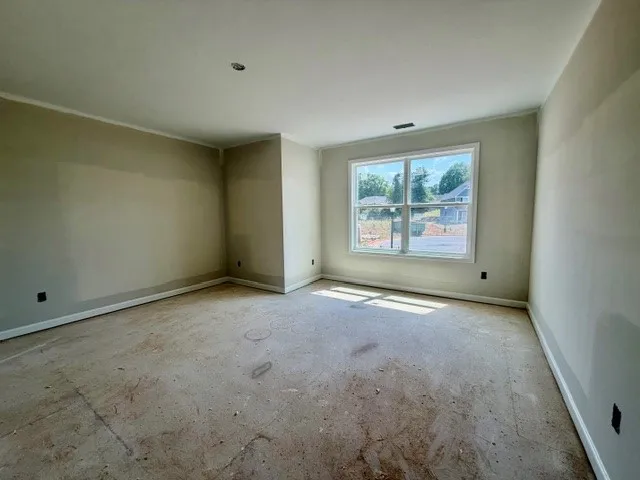 This spacious room offers natural light, ready for personalized flooring and finishes.