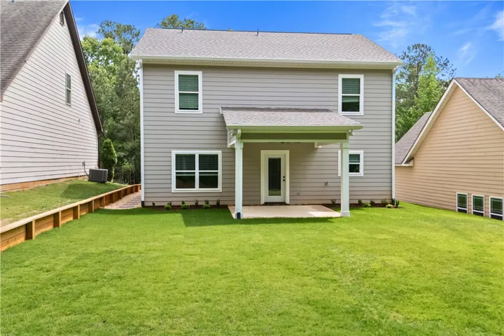 The home features a covered patio and a well-maintained backyard, with plenty of space for family and friends, and even game day fun.