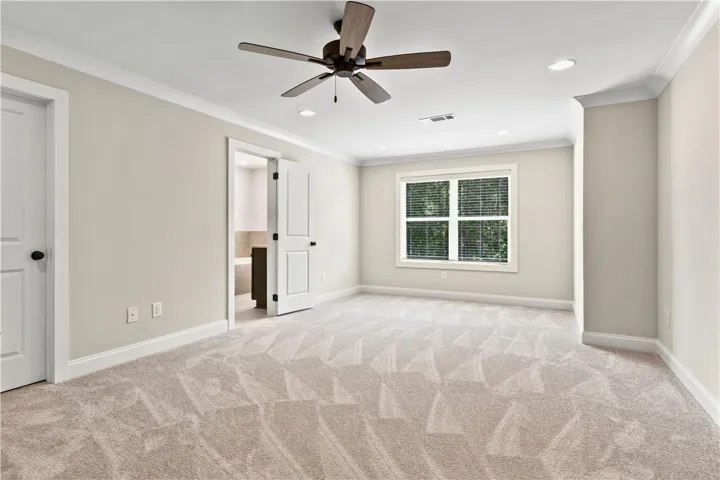 This sitting area in the primary bedroom offers a peaceful retreat with ample natural light.