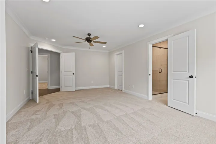 This spacious primary bedroom with sitting area offers comfort and direct access to the walk in closet and a separate private bath area.