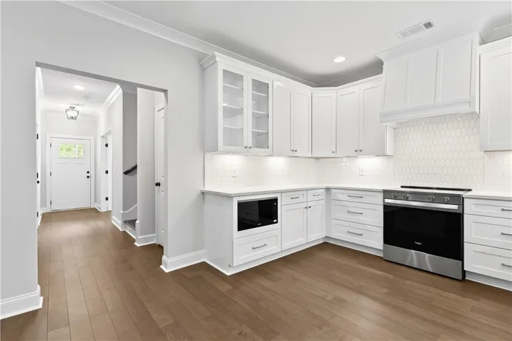 This modern kitchen offers sleek cabinetry, ample counter space, and integrated appliances.
