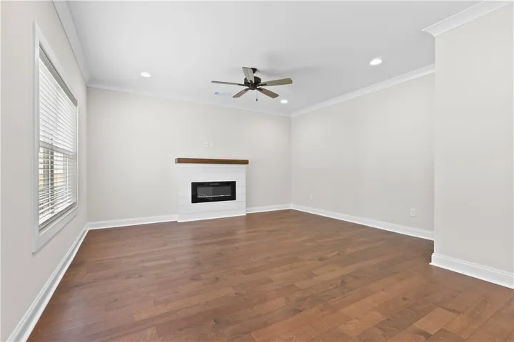 This inviting space features the elegant hardwood flooring and a charming electric fireplace, perfect for relaxation.