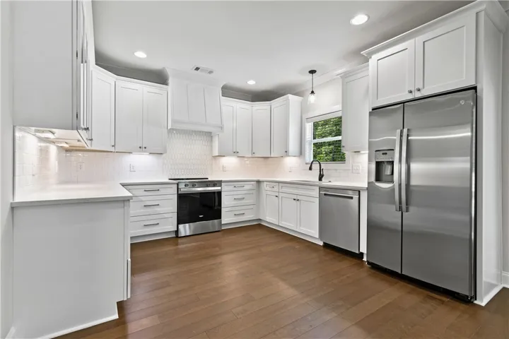 This bright kitchen features hardwood floors and modern stainless appliances, perfect for everyday living.