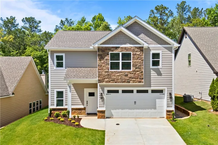 This beautiful new construction residence features a well-maintained exterior made of Hardie siding and a welcoming curb appeal.