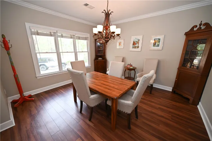 Formal dining room filled with sunlight.