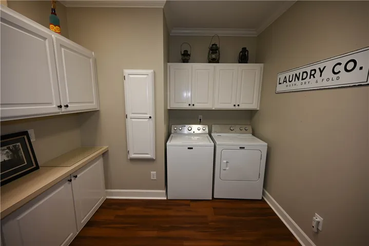 Generous laundry room with countertop space and so many cabinets!