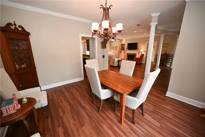 Dining room is finished with a beautiful chandelier.