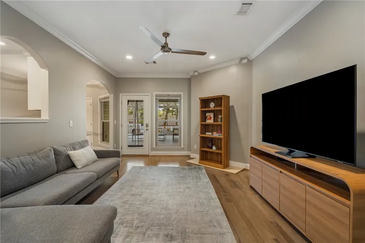 Spacious living room with a view of the back deck and planters.