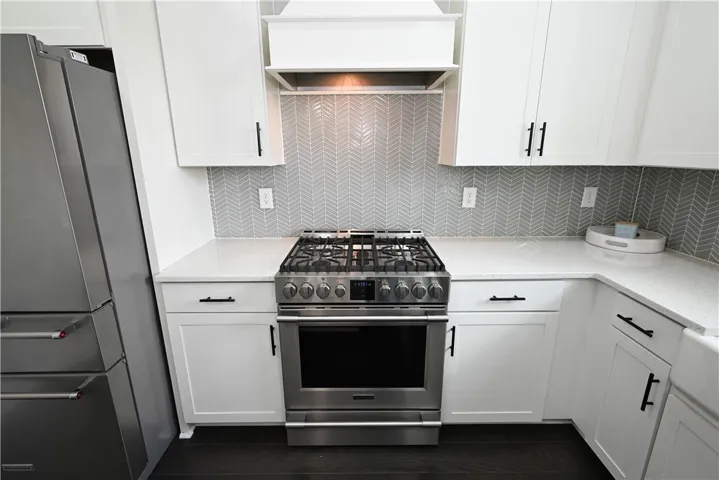 Gorgeous tiled backsplash & upgraded gas range.