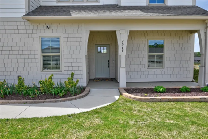 Welcoming flower beds & covered front porch!